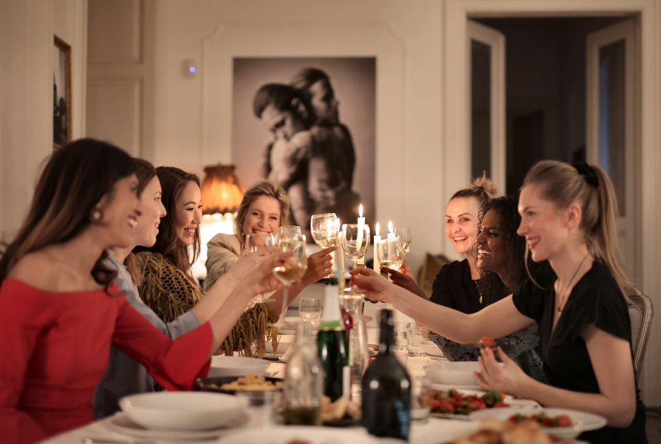 Group of People Sitting on Dining Table